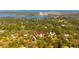 Aerial view highlights a wooded lot, close to nearby town, airport and body of water at 1370 Jane Lacey Ln, New Smyrna Beach, FL 32168