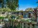 Backyard view showcasing a partially covered patio with string lights and mature landscaping for outdoor enjoyment at 1370 Jane Lacey Ln, New Smyrna Beach, FL 32168