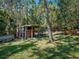 Backyard chicken coop includes a screened enclosure with access to an outside yard, offering a setup for poultry enthusiasts at 1370 Jane Lacey Ln, New Smyrna Beach, FL 32168