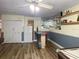 Finished basement with a bar, mirrored shelving, and light wood-look flooring offers space to entertain at 1370 Jane Lacey Ln, New Smyrna Beach, FL 32168