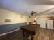 Basement with painted walls, laminate flooring, a ceiling fan, and a pool table at 1370 Jane Lacey Ln, New Smyrna Beach, FL 32168