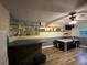 Basement boasts an air hockey table, stylish bar area with laminate floors and natural light at 1370 Jane Lacey Ln, New Smyrna Beach, FL 32168