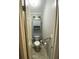 Powder room featuring a standard toilet, grab bar, bead board and a small storage cabinet at 1370 Jane Lacey Ln, New Smyrna Beach, FL 32168