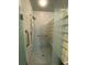 Shower stall featuring tiled walls, a glass block partition and chrome fixtures at 1370 Jane Lacey Ln, New Smyrna Beach, FL 32168
