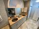 Bathroom with a double sink vanity, custom sinks and a large mirror, tile flooring, and bathroom storage at 1370 Jane Lacey Ln, New Smyrna Beach, FL 32168