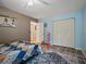 Bedroom with a ceiling fan, wood flooring, closet and a bed with a colorful quilt at 1370 Jane Lacey Ln, New Smyrna Beach, FL 32168