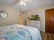 Bright bedroom features a ceiling fan, wood flooring, and a white dresser with mounted television at 1370 Jane Lacey Ln, New Smyrna Beach, FL 32168