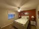 Bedroom with a queen bed, two nightstands, a ceiling fan and warm colored walls at 1370 Jane Lacey Ln, New Smyrna Beach, FL 32168