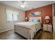 Cozy bedroom features a ceiling fan, beach themed artwork, and a comfortable bed with patterned bedding at 1370 Jane Lacey Ln, New Smyrna Beach, FL 32168