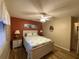 Bedroom with a queen bed, two nightstands, a ceiling fan, and plank flooring at 1370 Jane Lacey Ln, New Smyrna Beach, FL 32168