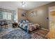 Inviting bedroom features a ceiling fan, wood flooring, and a comfortable bed with a colorful quilt at 1370 Jane Lacey Ln, New Smyrna Beach, FL 32168