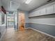 Bonus room with light wood-look floors, white cabinets, and access to the outdoors at 1370 Jane Lacey Ln, New Smyrna Beach, FL 32168