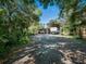 Long gravel driveway leading to multiple carports offers plenty of shaded parking for recreational vehicles at 1370 Jane Lacey Ln, New Smyrna Beach, FL 32168