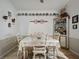 Dining area featuring white table and chairs with decorative wall shelves at 1370 Jane Lacey Ln, New Smyrna Beach, FL 32168