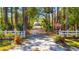 Gated entrance leads to a private driveway, showcasing the serene setting of the property at 1370 Jane Lacey Ln, New Smyrna Beach, FL 32168