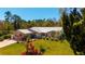 Attractive home with manicured lawn and landscaping showcasing curb appeal with mature trees at 1370 Jane Lacey Ln, New Smyrna Beach, FL 32168