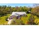 Beautiful single-story home with a metal roof, brick accents and a well-manicured lawn with mature landscaping at 1370 Jane Lacey Ln, New Smyrna Beach, FL 32168