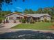 Charming brick home with a well-manicured lawn and colorful landscaping at 1370 Jane Lacey Ln, New Smyrna Beach, FL 32168