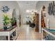 Bright hallway featuring tile floors, archways, and decorated with plants at 1370 Jane Lacey Ln, New Smyrna Beach, FL 32168