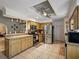 Spacious kitchen featuring tile floors, granite countertops, stainless steel appliances and a ceiling fan at 1370 Jane Lacey Ln, New Smyrna Beach, FL 32168