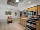 Kitchen area featuring wooden cabinetry, stainless appliances, and tile flooring at 1370 Jane Lacey Ln, New Smyrna Beach, FL 32168