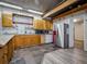 Kitchen with wooden cabinets, stainless steel refrigerator, and durable tile flooring at 1370 Jane Lacey Ln, New Smyrna Beach, FL 32168