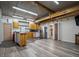 Open kitchen with wooden cabinets, stainless steel refrigerator, and durable vinyl flooring at 1370 Jane Lacey Ln, New Smyrna Beach, FL 32168