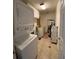 Efficient laundry room with tiled floor, stacked washer/dryer, and built-in cabinets at 1370 Jane Lacey Ln, New Smyrna Beach, FL 32168