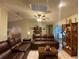 Open living room offers comfortable leather furniture, arched doorways, and natural light at 1370 Jane Lacey Ln, New Smyrna Beach, FL 32168