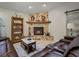 Cozy living room with a stone fireplace and comfortable leather seating at 1370 Jane Lacey Ln, New Smyrna Beach, FL 32168