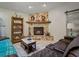 Cozy living room featuring a stone fireplace, wood floors, and comfortable seating at 1370 Jane Lacey Ln, New Smyrna Beach, FL 32168