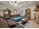 Comfortable living room with stone fireplace, display shelving, and ample seating at 1370 Jane Lacey Ln, New Smyrna Beach, FL 32168