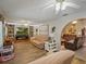 Open-concept living room with built-in bookshelves, fireplace, and hardwood floors at 1370 Jane Lacey Ln, New Smyrna Beach, FL 32168