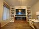 Living room with a built-in entertainment center featuring an electric fireplace and shelving at 1370 Jane Lacey Ln, New Smyrna Beach, FL 32168