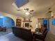 Cozy living room showcasing a stone fireplace, vaulted ceiling, and comfortable leather seating at 1370 Jane Lacey Ln, New Smyrna Beach, FL 32168