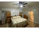 Comfortable main bedroom with fan, floral bedding, and hardwood floors at 1370 Jane Lacey Ln, New Smyrna Beach, FL 32168