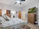 Bright main bedroom with floral bedding, TV, and ensuite access at 1370 Jane Lacey Ln, New Smyrna Beach, FL 32168