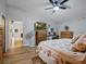 Bright main bedroom featuring television, desk, and floral bedding at 1370 Jane Lacey Ln, New Smyrna Beach, FL 32168
