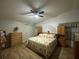 Inviting main bedroom featuring hardwood floors and a comfortable bed with floral bedding at 1370 Jane Lacey Ln, New Smyrna Beach, FL 32168