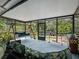 Relaxing screened-in porch with a swing, comfortable seating, and views of lush landscaping at 1370 Jane Lacey Ln, New Smyrna Beach, FL 32168