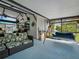 Covered porch features comfortable seating, a swing, and an open view of the outdoor pool at 1370 Jane Lacey Ln, New Smyrna Beach, FL 32168