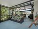 Spacious screened-in porch with ample seating, offering an ideal space for relaxation and gatherings at 1370 Jane Lacey Ln, New Smyrna Beach, FL 32168
