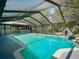 Screened-in pool featuring a slide for added enjoyment and clear blue water at 1370 Jane Lacey Ln, New Smyrna Beach, FL 32168