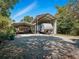 This home features covered parking for an RV and other vehicles on a gravel lot at 1370 Jane Lacey Ln, New Smyrna Beach, FL 32168
