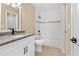 Well-lit bathroom featuring a granite countertop vanity and tiled shower at 1600 Big Tree Rd # G3, South Daytona, FL 32119