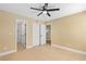 Spacious bedroom with tile flooring, ceiling fan, and multiple closets for ample storage at 1600 Big Tree Rd # G3, South Daytona, FL 32119