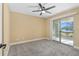 Bedroom with sliding glass door to a balcony overlooking a lake at 1600 Big Tree Rd # G3, South Daytona, FL 32119