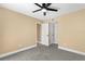 Neutral bedroom features gray carpet, white trim, ceiling fan, and two closets at 1600 Big Tree Rd # G3, South Daytona, FL 32119