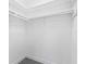 Walk-in closet has a white interior with shelving and rod for storage at 1600 Big Tree Rd # G3, South Daytona, FL 32119