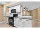 Modern kitchen featuring white cabinets, granite countertops, and stainless steel appliances at 1600 Big Tree Rd # G3, South Daytona, FL 32119